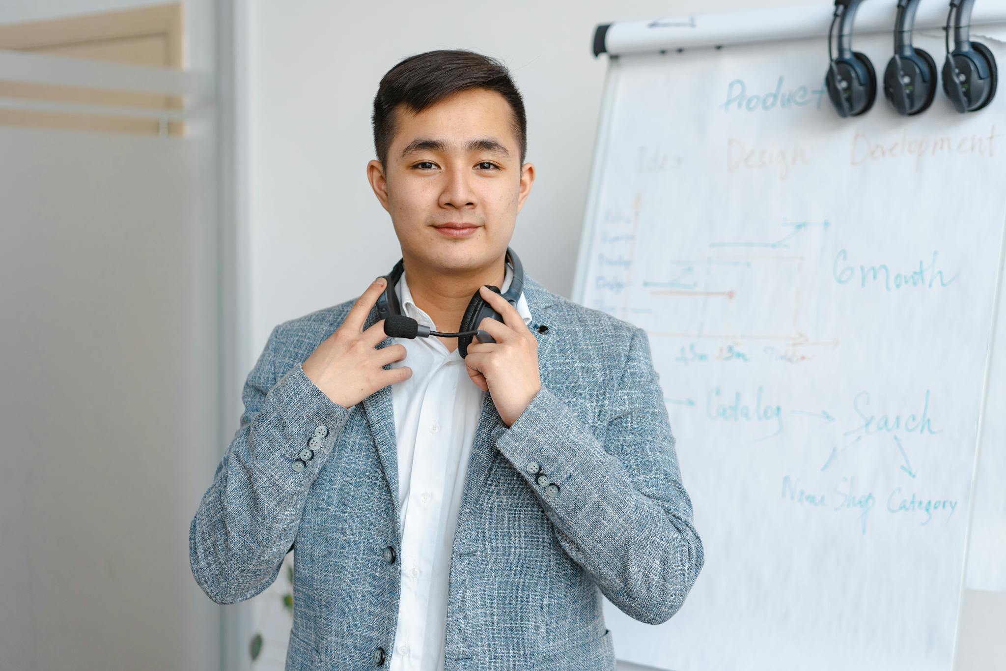 Portrait of a young man with a headset in a modern office environment.